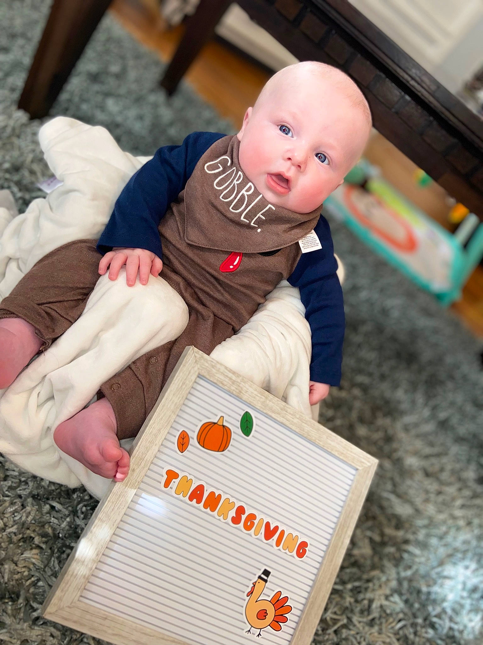 Bradley is registered to the contest to win money with this photo: baby, baby_products, baby_toddler_clothing, child, event, face, finger, flooring, foot, fun, hand, happy, knee, leg, person, play, recreation, sleeve, sock, toddler