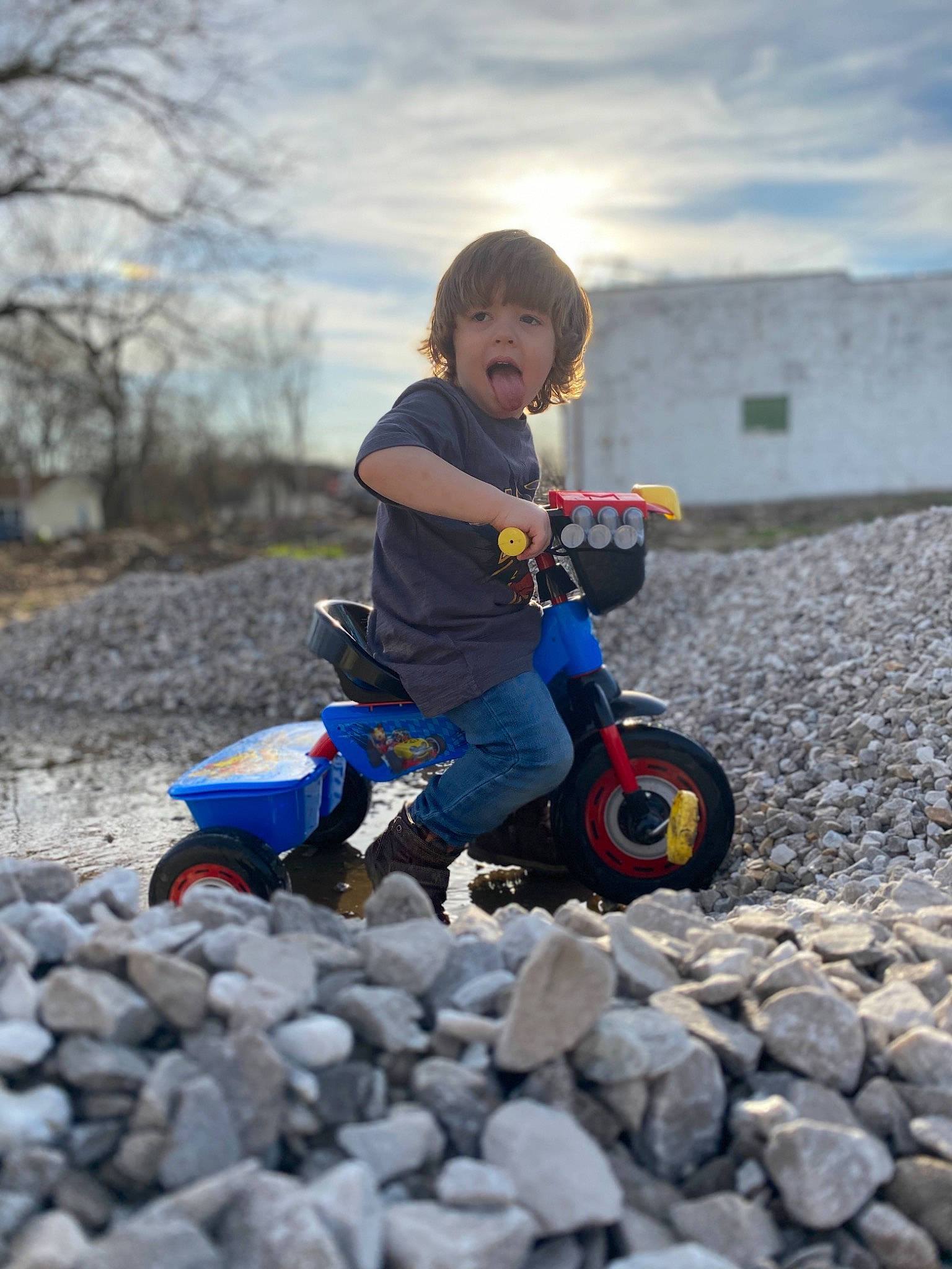 Carter is registered to the contest to win money with this photo: automotive_wheel_system, child, person, play, riding_toy, toddler, tricycle, vehicle, wheel