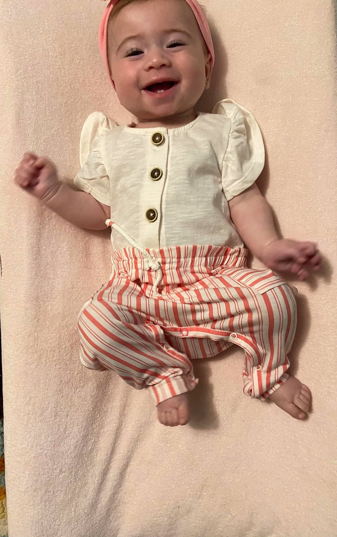 Clementine is registered to the contest to win money with this photo: baby, baby_toddler_clothing, cheek, child, collar, dress, eye, face, finger, gesture, happy, head, joy, pattern, person, pink, skin, sleeve, smile, thumb