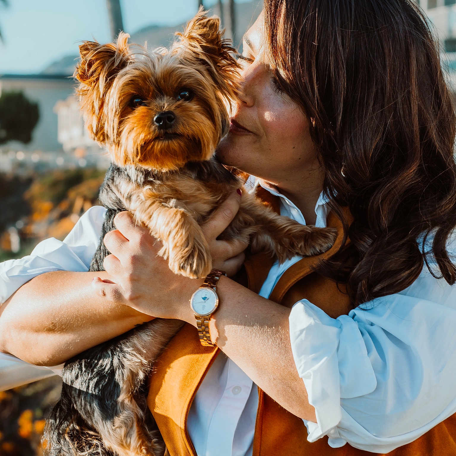 Rockette joined the competition — help win amazing prizes! woman, dog, yorkshire_terrier, pet, outdoor, sunlight, affection, holding, watch, white_shirt, orange_vest, portrait, smiling, hair, face, cute, animal, companion, nature, background_blur