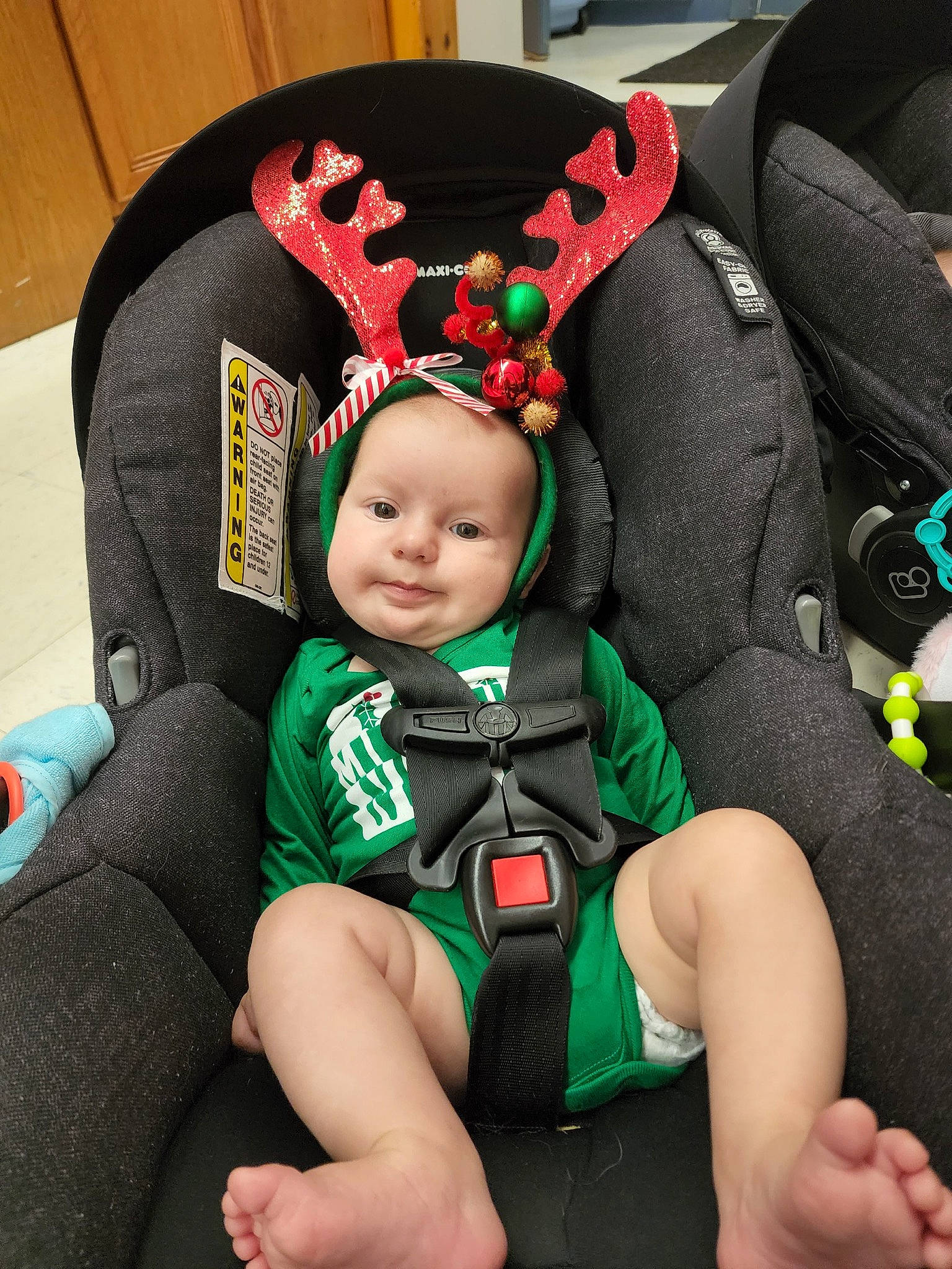Beau joined the competition — help win amazing prizes! baby, baby_carriage, baby_products, baby_safety, baby_sleeping, baby_toddler_clothing, car_seat, child, comfort, costume_hat, fashion_accessory, fun, green, happy, headwear, person, personal_protective_equipment, product, sitting, steering_wheel