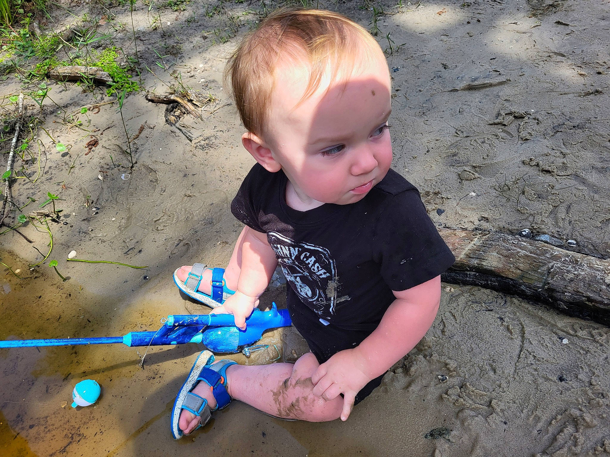 Mark is registered to the contest to win money with this photo: baby, baby_toddler_clothing, beauty, child, electric_blue, fun, grass, landscape, leisure, people_in_nature, person, play, sand, sitting, soil, summer, toddler, toy, tree, vacation