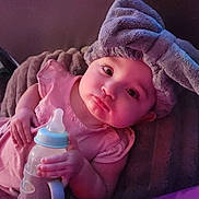 Mercy joined the competition — help win amazing prizes! baby, infant, bottle, headband, bow, pink_clothing, lying_down, hand, face, expression, soft_light, blanket, indoors, cute, child, portrait, young, bottle_holder, sleepwear, resting