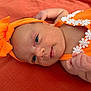 Inaya a rejoint le concours — aidez-le/la à gagner de superbes lots ! baby, infant, orange_headband, orange_outfit, white_flowers, close_up, face, hand, skin, newborn, lying_down, fabric, texture, soft_light, portrait, cute, child, headwear, fashion, background