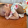 Inaya participe au concours pour gagner de l'argent avec cette photo : baby, sleeping, infant, colorful_clothing, blanket, orange, texture, closeup, peaceful, rest, child, skin, hand, face, portrait, soft_light, indoors, cute, newborn, cozy