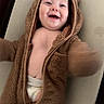 James is registered to the contest to win money with this photo: baby, child, smiling, laughing, onesie, hood, bear_ears, fuzzy_clothing, infant, cute, happy, diaper, candid, portrait, indoor, soft_texture, warm_clothing, playful, baby_gesture, closeup