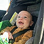 baby, infant, car_seat, child, smiling, happy, blanket, seatbelt, clothing, indoors, car, safety, cute, portrait, young_child, baby_boy, secure, sunlight, closeup, seat