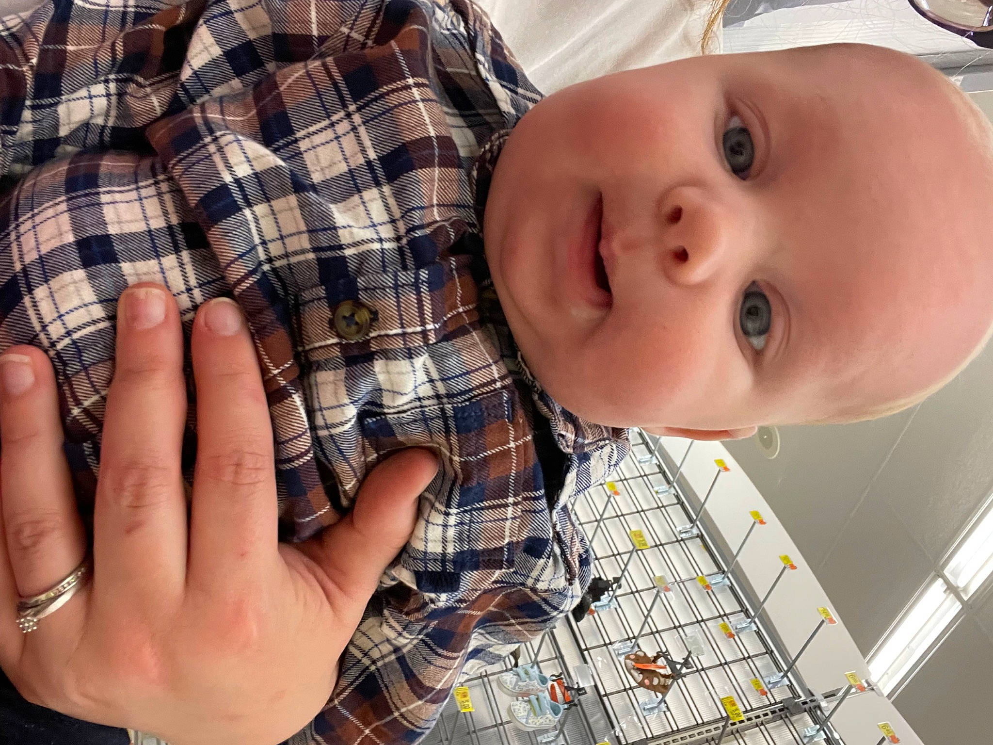 Weston is registered to the contest to win money with this photo: baby, baby_toddler_clothing, cheek, eye, eyelash, finger, gesture, happy, human_body, lip, mouth, nail, nose, pattern, person, plaid, skin, sleeve, smile, tartan