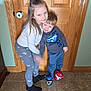 Eli is registered to the contest to win money with this photo: child, children, hug, indoor, door, wooden_door, boy, girl, leggings, slippers, paw_patrol, smile, happy, floor, tile_floor, long_hair, short_hair, casual_clothing, family, siblings