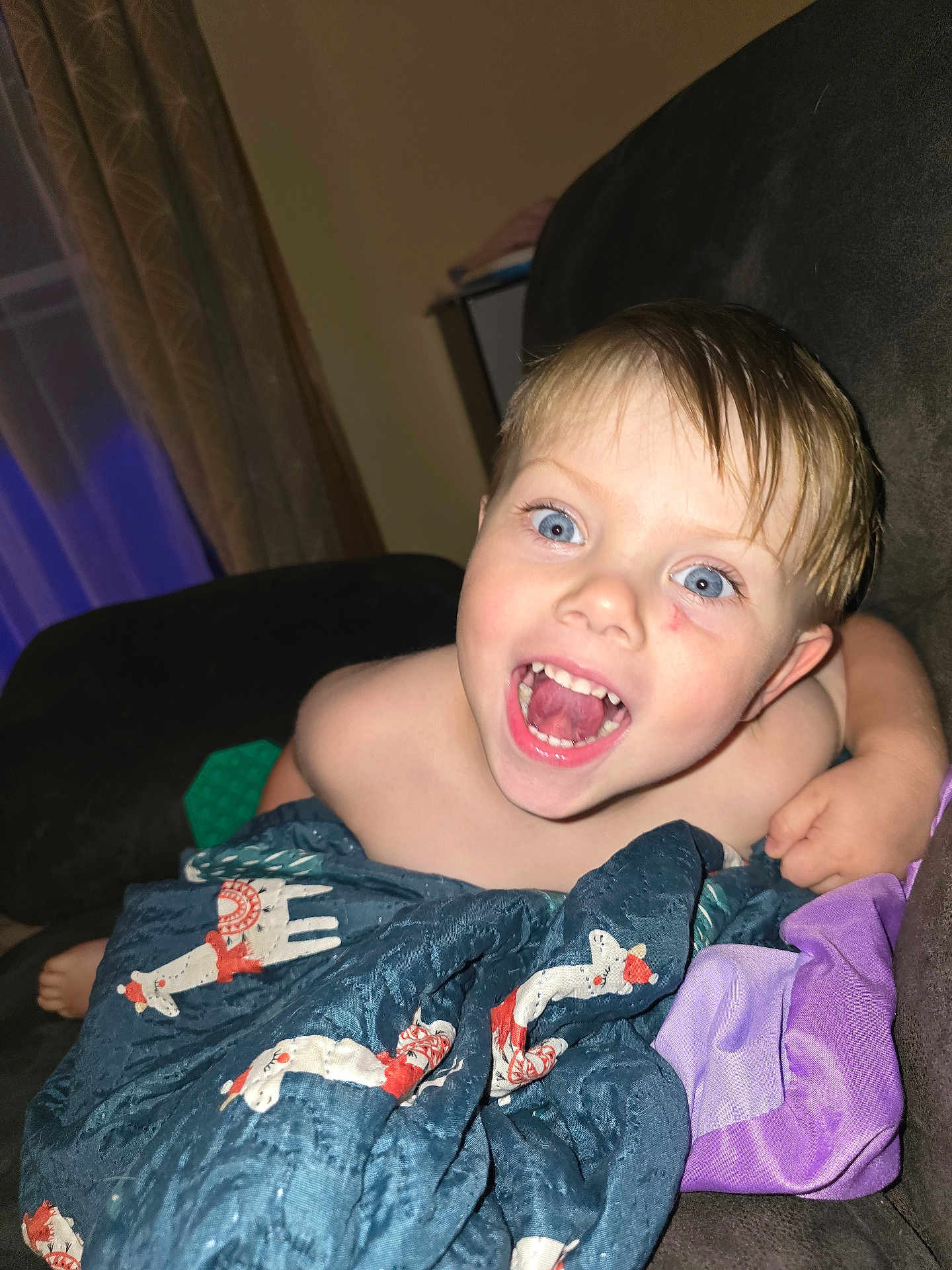 Eli joined the competition — help win amazing prizes! child, toddler, blanket, blue_eyes, smiling, happy, indoor, couch, fabric, wet_hair, person, cute, playful, home, comfort, wrapped, expression, face, sitting, young