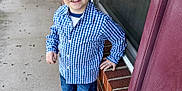 Eli joined the competition — help win amazing prizes! child, boy, smiling, blue_checkered_shirt, jeans, black_shoes, porch, brick_wall, window, sidewalk, casual_pose, outdoor, daylight, happy, person, young, short_hair, hand_on_hip, concrete, home_exterior