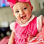 baby, child, smiling, pink_bow, pink_dress, indoor, portrait, happy, cute, infant, headwear, face, eyes, hand, soft_focus, person, clothing, skin, cheeks, closeup