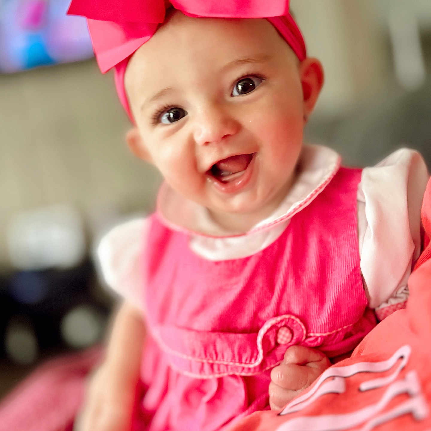 Blakeleigh is registered to the contest to win money with this photo: baby, cheeks, child, closeup, clothing, cute, eyes, face, hand, happy, headwear, indoor, infant, person, pink_bow, pink_dress, portrait, skin, smiling, soft_focus