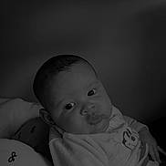 Keylan participe au concours pour gagner de l'argent avec cette photo : baby, blanket, cartoon_character, child, chubby_cheeks, clothing, comfort, cozy, cute, expression, eyes, face, indoors, infant, laying, person, portrait, sitting, soft_light, young