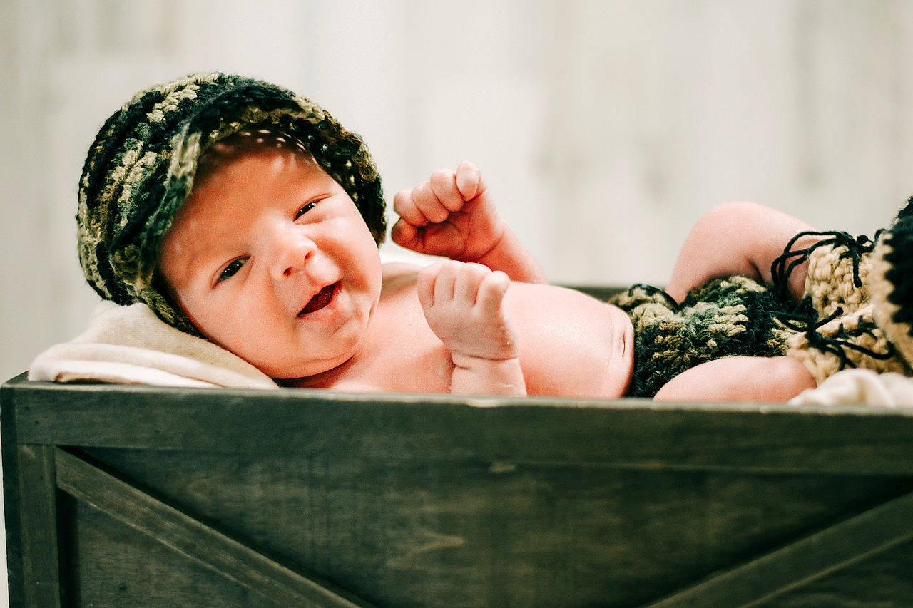 Emmitt is registered to the contest to win money with this photo: baby, baby_sleeping, baby_toddler_clothing, cap, child, comfort, eye, fashion_accessory, flash_photography, foot, grass, hair_accessory, happy, headpiece, headwear, human_body, knit_cap, person, sitting, skin