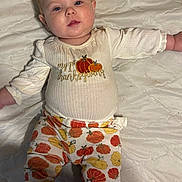 Raelynn Grace joined the competition — help win amazing prizes! baby, infant, child, pajamas, pumpkin, thanksgiving, bed, quilt, blanket, clothing, person, cute, relaxed, indoors, sleepwear, comfort, lying_down, face, head, skin