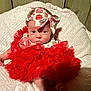 Raelynn Grace is registered to the contest to win money with this photo: baby, infant, tutu, red_dress, headband, bow, strawberry_pattern, tongue_out, blanket, wooden_wall, cute, adorable, cheeky, soft_texture, clothing, person, face, foot, hand, sitting