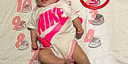 Raelynn Grace joined the competition — help win amazing prizes! baby, infant, pink, onesie, headband, flower, blanket, numbers, sneakers, red_ring, lying_down, cute, child, smiling, clothing, foot, hand, skin, expression, indoors