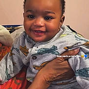 Micah joined the competition — help win amazing prizes! airplane, apparel, baby, blanket, child, clothing, cute, face, hand, happy, holding, indoors, infant, onesie, pattern, person, portrait, skin, smiling, warm