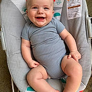 Henry joined the competition — help win amazing prizes! baby, smiling, onesie, gray_clothing, bouncer, baby_bouncer, infant, happy, cute, chubby_legs, indoor, patterned_fabric, monkey_design, rainbow_design, seat, child, portrait, skin, head, expression