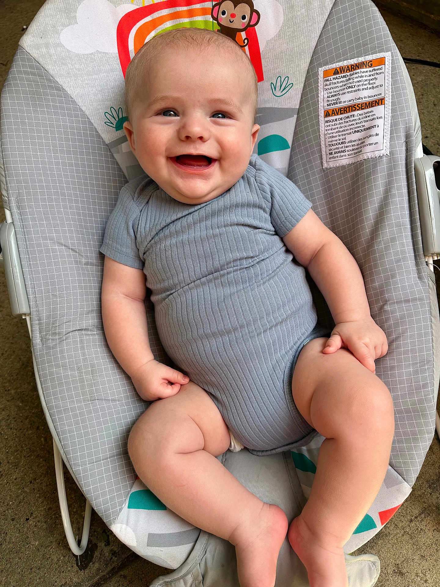 Henry joined the competition — help win amazing prizes! baby, smiling, onesie, gray_clothing, bouncer, baby_bouncer, infant, happy, cute, chubby_legs, indoor, patterned_fabric, monkey_design, rainbow_design, seat, child, portrait, skin, head, expression