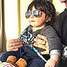 Dylan participe au concours pour gagner de l'argent avec cette photo : child, toddler, sunglasses, toy, adult, hand, watch, clothing, beads, pacifier_clip, sunlight, indoor, person, portrait, smile, hair, seat, casual, reflection, accessory