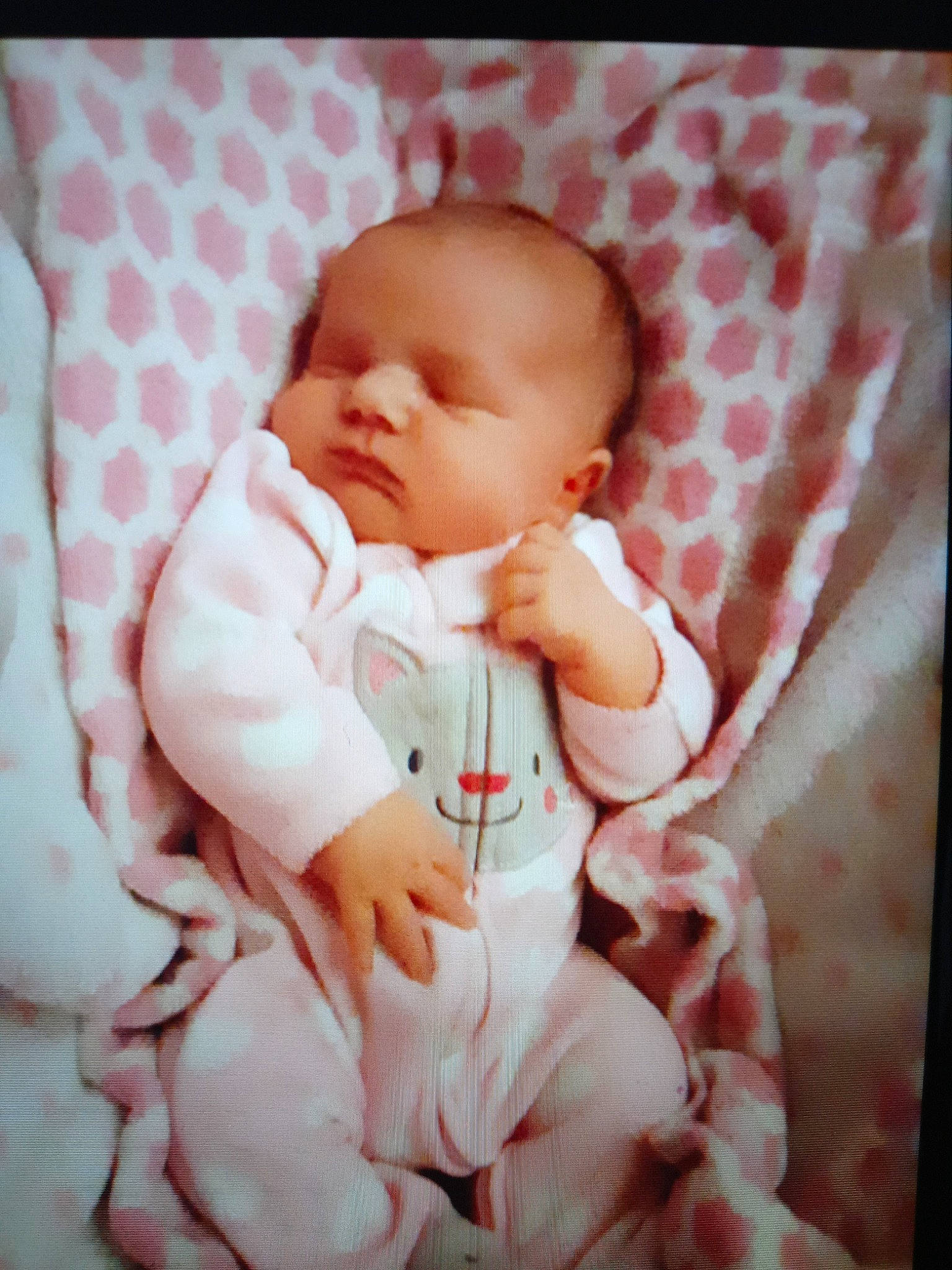 Amelia is registered to the contest to win money with this photo: arm, baby, baby_products, baby_sleeping, baby_toddler_clothing, cheek, child, collar, comfort, linens, pattern, peach, person, pink, portrait_photography, product, sitting, skin, sleeve, thumb