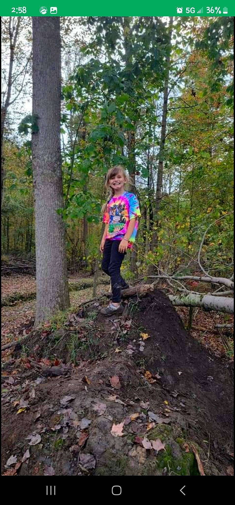 Emily is registered to the contest to win money with this photo: boot, deciduous, forest, fun, grass, joy, jungle, landscape, natural_landscape, people_in_nature, person, plant, recreation, soil, terrestrial_plant, toddler, trail, tree, trunk, twig