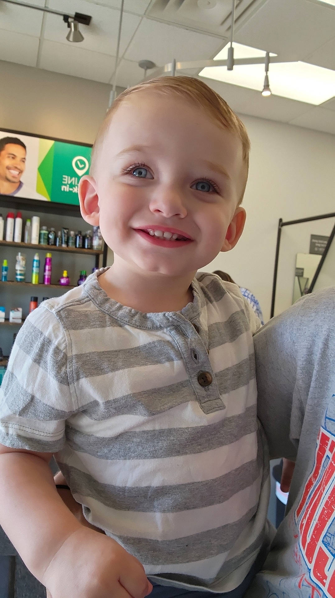 Tanner joined the competition — help win amazing prizes! adult, baby, bodypart, book, clothing, face, finger, hand, happy, head, indoors, library, male, man, person, photography, portrait, shelf, smile, t_shirt