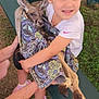 Jemma is registered to the contest to win money with this photo: child, kangaroo, animal, blanket, outdoor, grass, bench, hug, cute, happy, person, nature, wildlife, summer, casual_clothing, footwear, playful, young, park, daylight