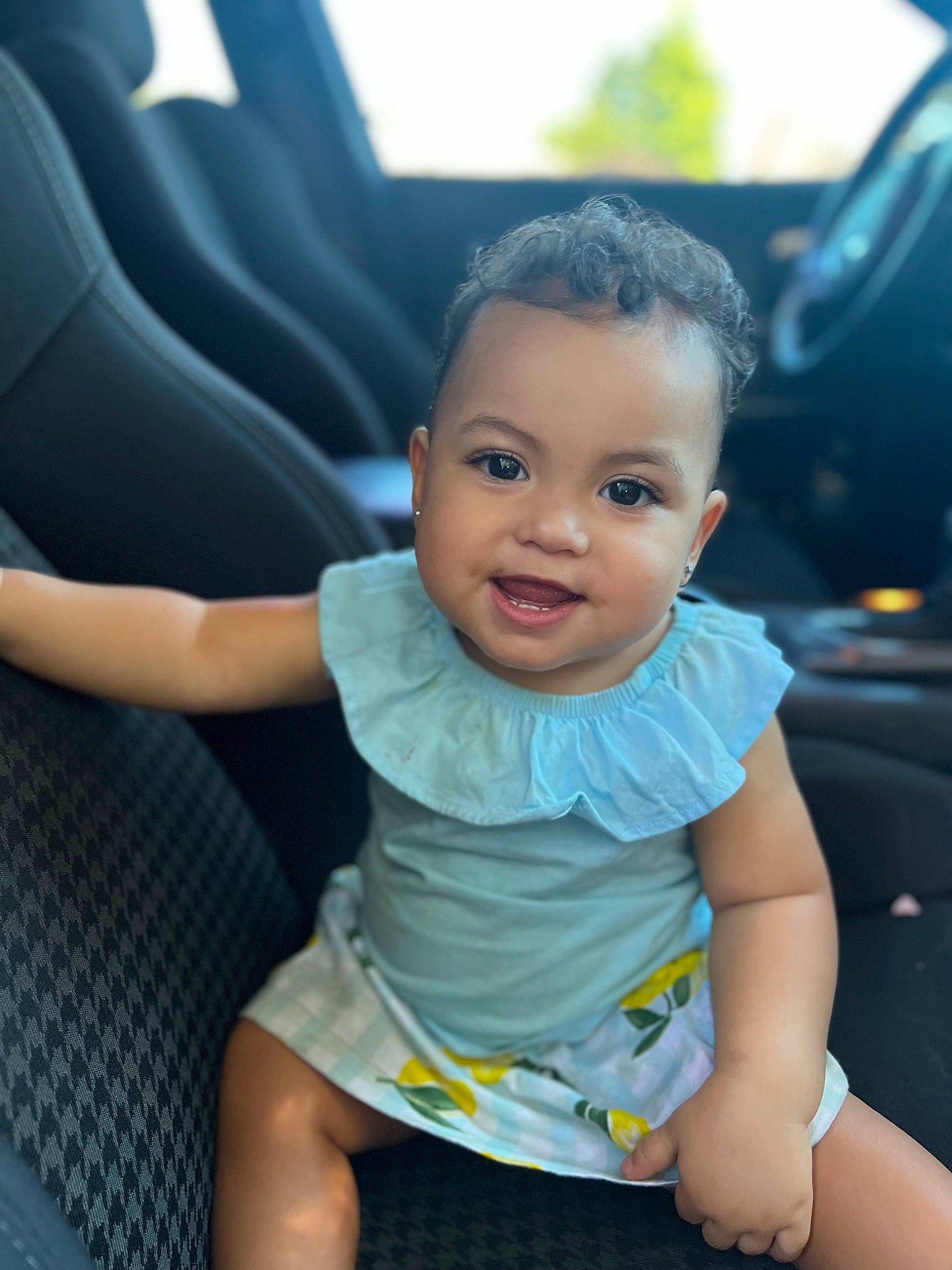 Mahina is registered to the contest to win money with this photo: auto_part, automotive_design, baby, baby_toddler_clothing, black_hair, car_seat, car_seat_cover, child, cool, face, finger, happy, leisure, person, seat_belt, skin, smile, thigh, toddler, vehicle_door