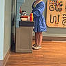 Brynnslee joined the competition — help win amazing prizes! child, girl, blue_dress, toy_kitchen, play_food, wooden_floor, playroom, bead_maze, wall_toys, indoor, young_child, curly_hair, casual_shoes, necklace, flooring, standing, colorful, pretend_play, furniture, serious_expression