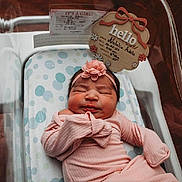 Natalia joined the competition — help win amazing prizes! newborn, baby, infant, sleeping, portrait, hospital, bassinet, pink_clothing, headband, flower, swaddled, lying_down, peaceful, nursery, birth_announcement, blanket, polka_dots, wood_floor, close_up, face