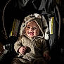 Brysen joined the competition — help win amazing prizes! baby, infant, car_seat, fuzzy_outfit, hood, smile, happy, child, cute, indoors, dark_background, clothing, seatbelt, portrait, face, cozy, warm, expression, young_child, toddler