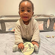 Aaron participe au concours pour gagner de l'argent avec cette photo : baby, infant, child, sitting, blanket, sign, elephant, months, clothing, socks, indoor, playpen, toy, curly_hair, smiling, cute, cozy, portrait, young_child, happy