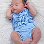 Vincent joined the competition — help win amazing prizes! baby, infant, sleeping, blue_clothing, floral_pattern, soft_texture, white_background, peaceful, cute, newborn, chubby_legs, tiny_feet, relaxed, indoors, portrait, child, smiling, resting, cozy, adorable