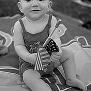 Lillian is registered to the contest to win money with this photo: baby, child, infant, headband, bow, flag, american_flag, outdoor, blanket, sitting, smile, cute, portrait, legs, hand, playful, monochrome, grass, summer, happy