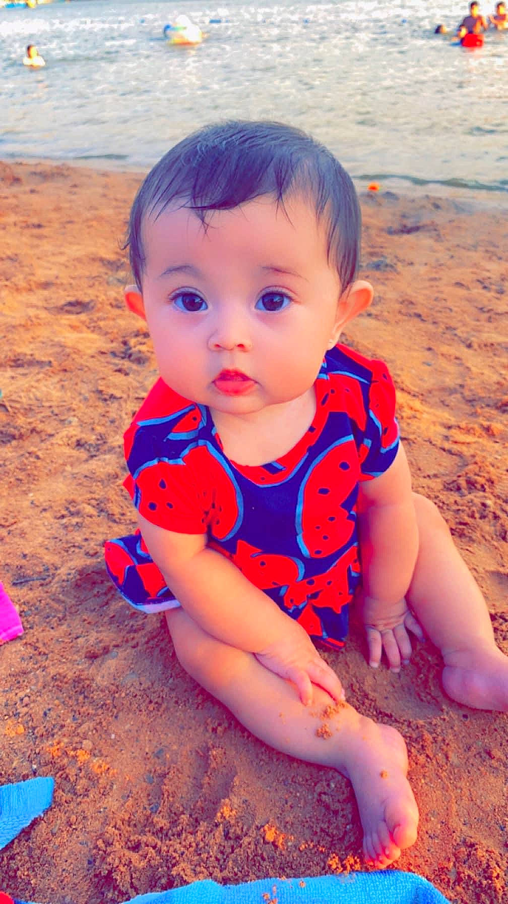 Jaylee joined the competition — help win amazing prizes! azure, baby, baby_toddler_clothing, beach, blue, child, cool, electric_blue, facial_expression, flooring, fun, happy, human_leg, leisure, people_in_nature, person, sand, standing, summer, sunlight