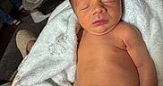 Blake is registered to the contest to win money with this photo: newborn, baby, infant, sleeping, portrait, face, blanket, diaper, indoors, home, sofa, baby_seat, cozy, peaceful, resting, bare_chested, lying_down, soft_blanket, photography, closeup