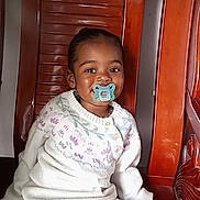 Keïlany participe au concours pour gagner de l'argent avec cette photo : toddler, child, pacifier, sweater, white_clothing, toy, wooden_chair, indoor, smiling, face, young_child, cute, sitting, sticker, playful, portrait, baby, cozy, comfort, casual