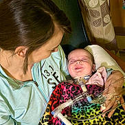 Madi is registered to the contest to win money with this photo: accessories, architecture, baby, blanket, building, childbirth, clothing, crib, face, furniture, head, hospital, infantbed, jewelry, necklace, newborn, person, photography, portrait, t_shirt