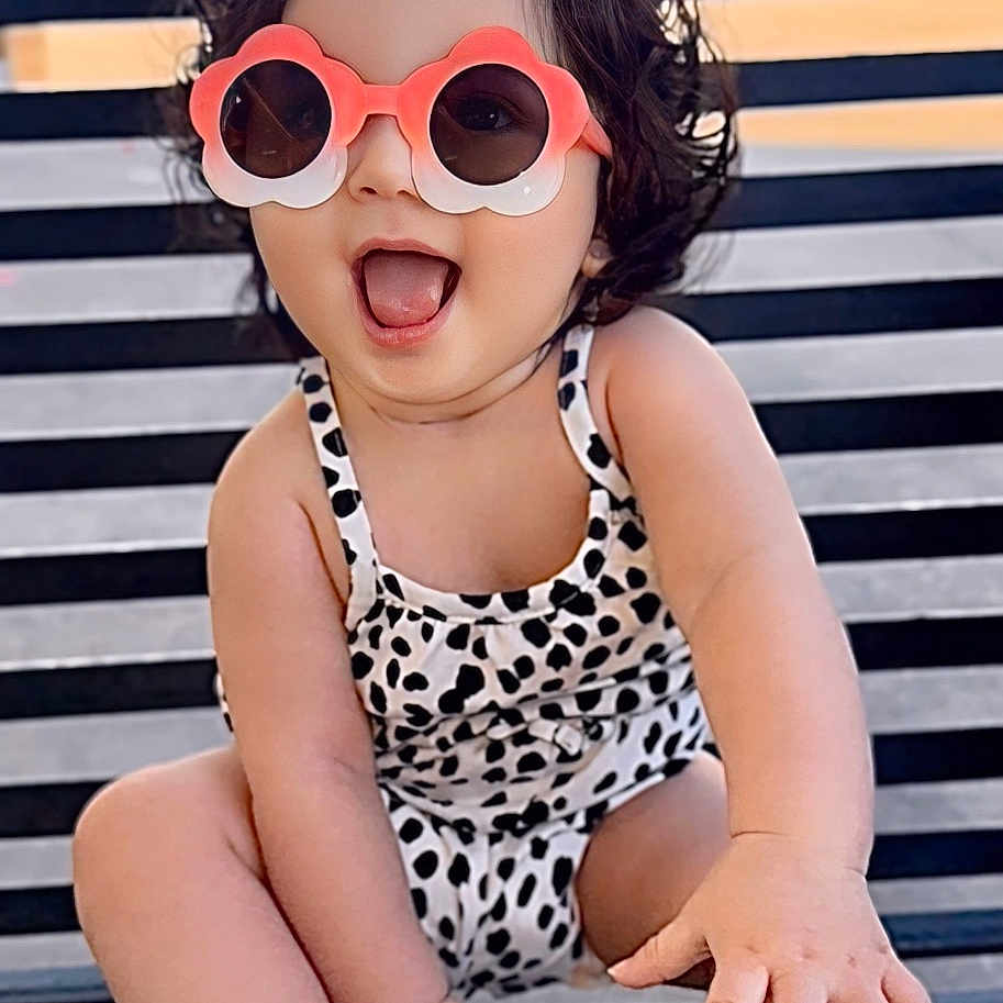 Lily joined the competition — help win amazing prizes! accessories, baby, bench, city, clothing, face, furniture, glasses, happy, head, person, photography, portrait, shorts, sitting, summer, sunglasses, swimwear, water, waterfront