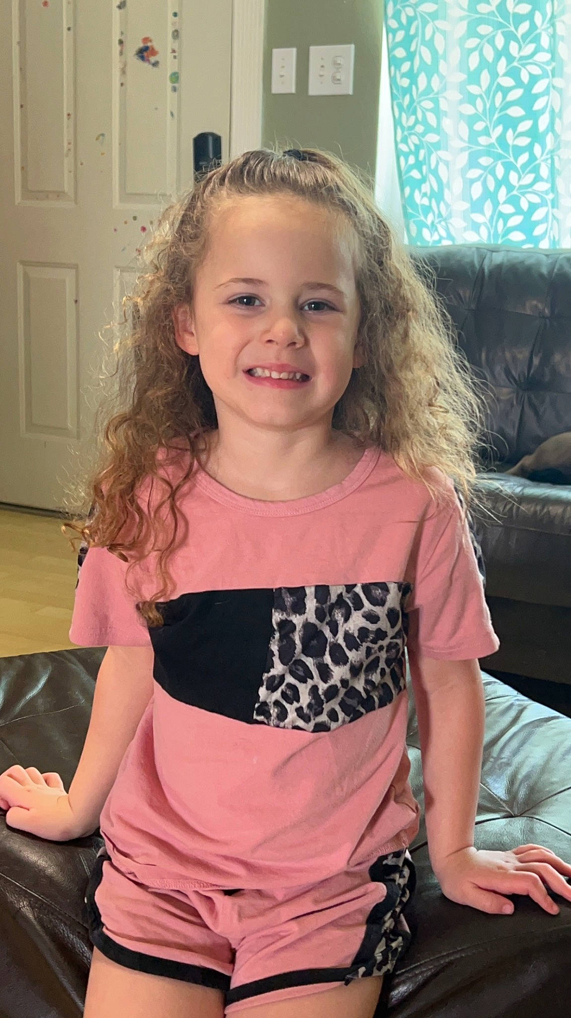 Zoey is registered to the contest to win money with this photo: abdomen, beauty, blond, brown_hair, child, door, fashion_design, fun, hairstyle, happy, iris, joy, long_hair, neck, person, shoulder, sleeve, smile, t_shirt, thigh