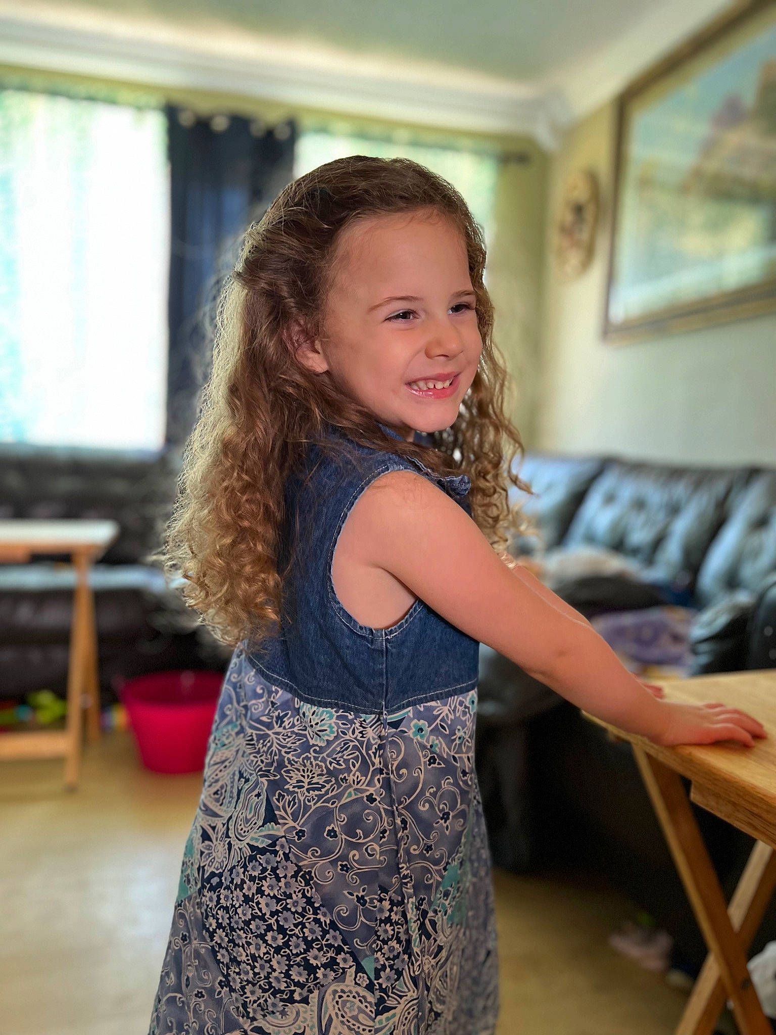 Zoey is registered to the contest to win money with this photo: blond, child, dress, fashion_design, flash_photography, flooring, fun, happy, joy, leisure, long_hair, neck, one_piece_garment, person, picture_frame, shoulder, smile, table, trunk, waist