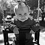 Victoire participe au concours pour gagner de l'argent avec cette photo : baby, child, swing, smiling, outdoor, playground, sunlight, black_and_white, portrait, infant, clothing, bow, happy, hands, seat, park, cute, person, young, fun
