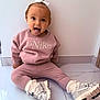 child, toddler, pink_clothing, nike, sneakers, white_bow, tongue_out, playful, sitting, floor, tile_floor, indoor, cute, happy, person, portrait, long_sleeves, leggings, white_socks, young_child