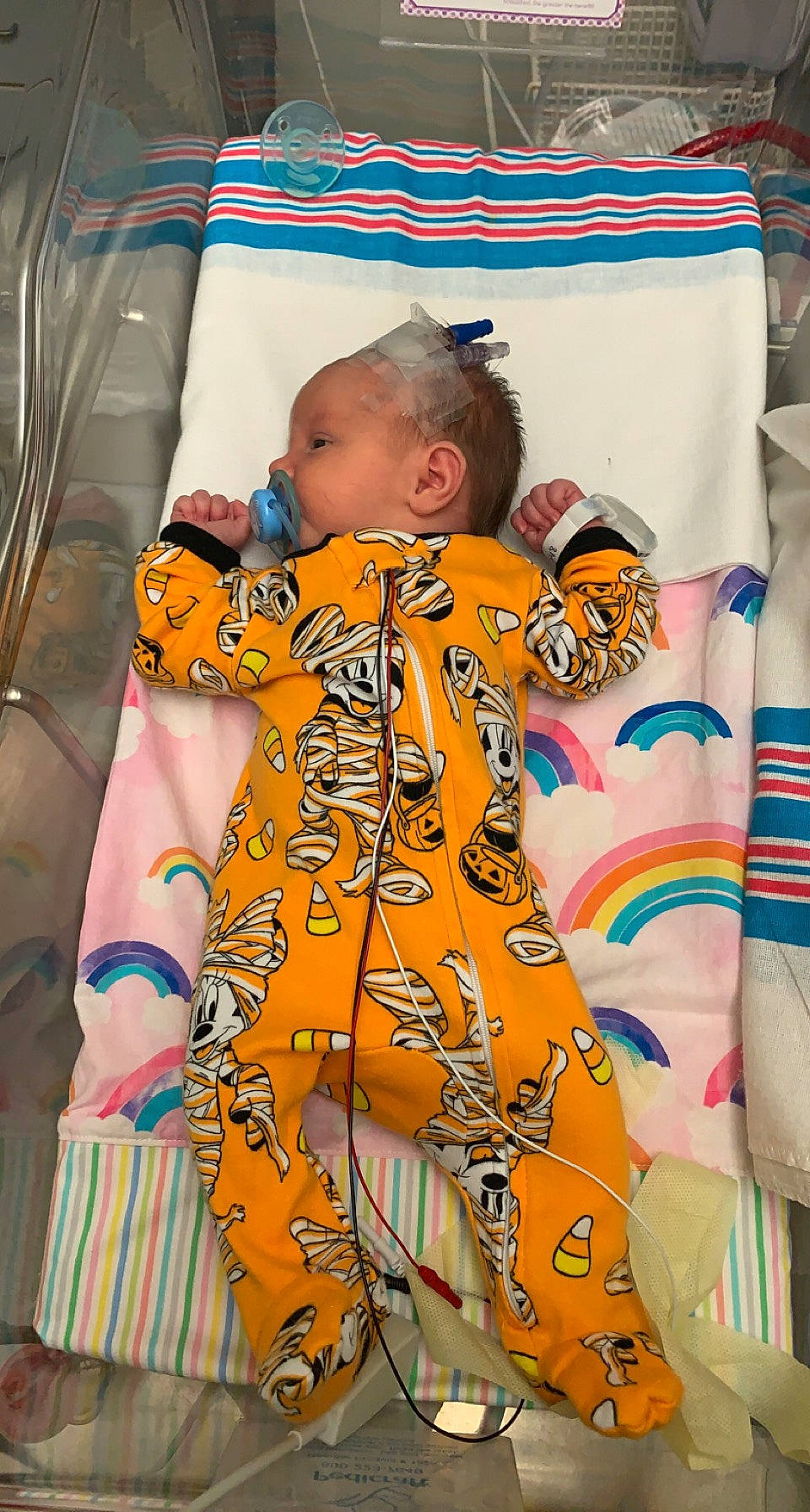 Evelyn joined the competition — help win amazing prizes! baby, baby_products, baby_safety, baby_toddler_clothing, child, comfort, event, face, fun, head, infant_bed, linens, orange, pattern, person, room, sitting, sleeve, stuffed_toy, t_shirt