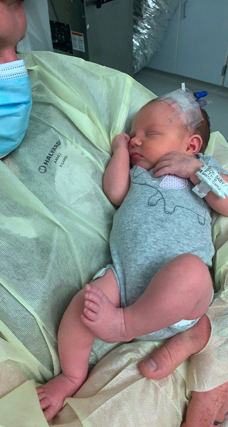 Evelyn joined the competition — help win amazing prizes! baby, baby_sleeping, baby_toddler_clothing, blue, cheek, child, comfort, facial_expression, finger, hospital, joint, lap, linens, mammal, mouth, person, skin, textile, thigh, toddler