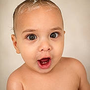 Liam is registered to the contest to win money with this photo: baby, child, face, expression, hair, mohawk, wet_hair, skin, portrait, cute, young, innocent, open_mouth, eyes, head, shoulders, closeup, surprised, studio, neutral_background