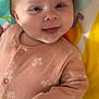 Nova is registered to the contest to win money with this photo: baby, smiling, infant, face, hair, clothing, onesie, pattern, floral, hand, playmat, colorful, musical_notes, heart, lying_down, cute, child, indoors, soft, happy